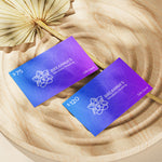Load image into Gallery viewer, Two purple gift cards with floral design and text on a wooden surface
